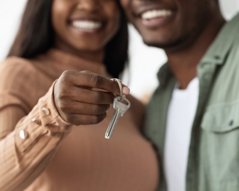 Couple holding keys to new apartment